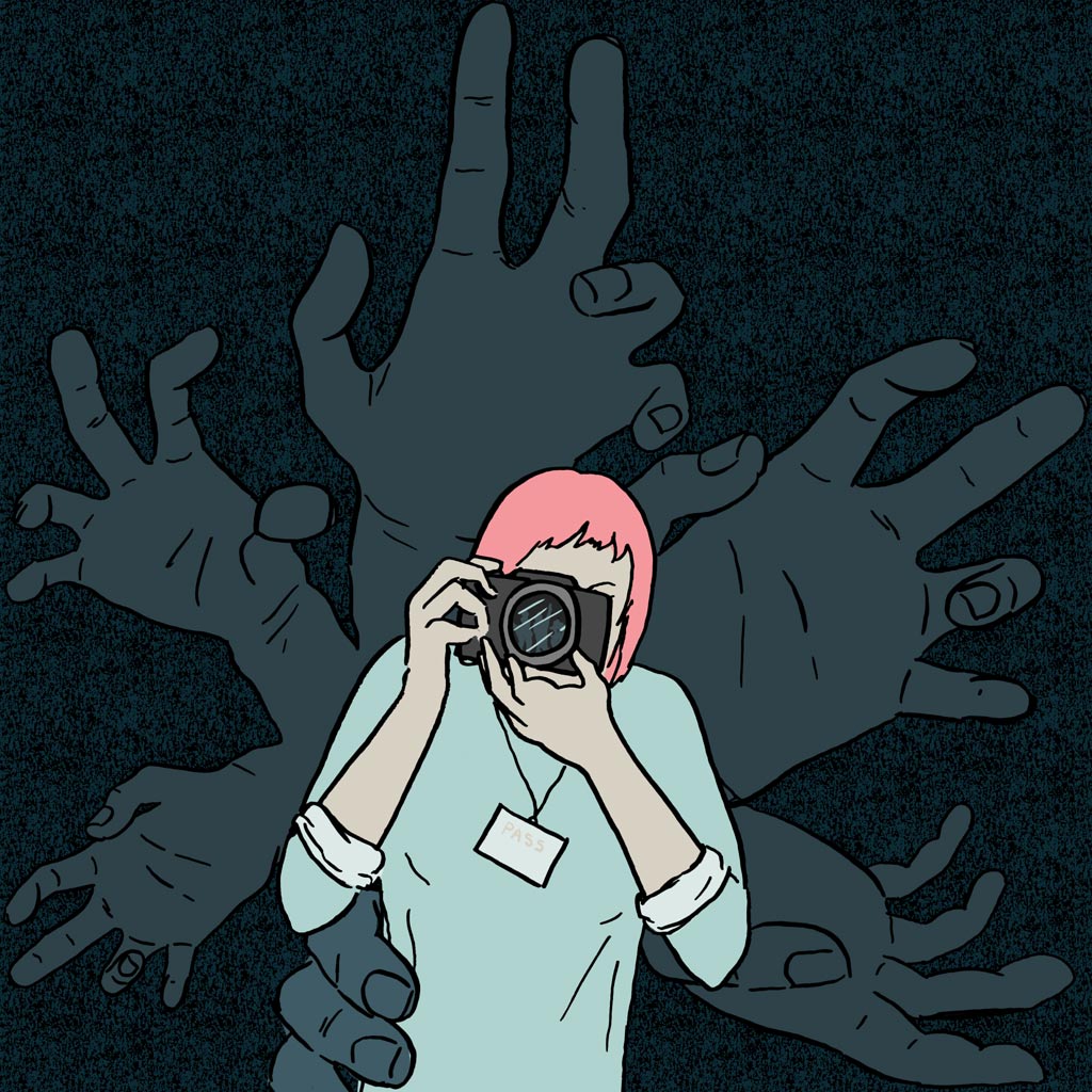 Velike šake iza žene sa fotoaparatom