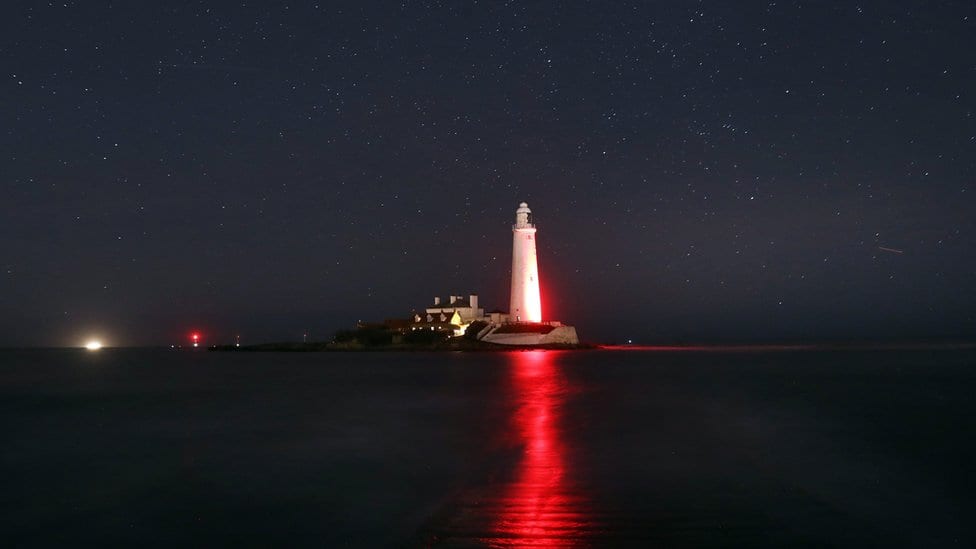 St Mary's Lighthouse, Whitley Bay, glows red in honour of the centenary