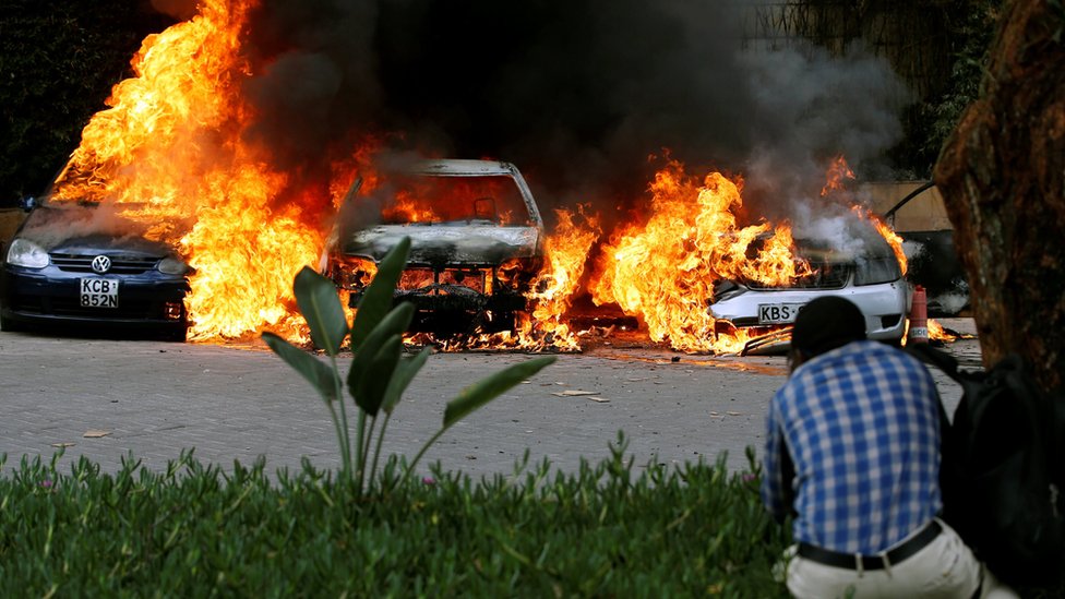 Cars are seen on fire in Nairobi, Kenya