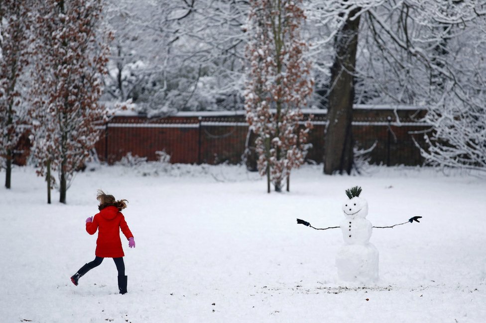 A child plays in the snow in Manchester