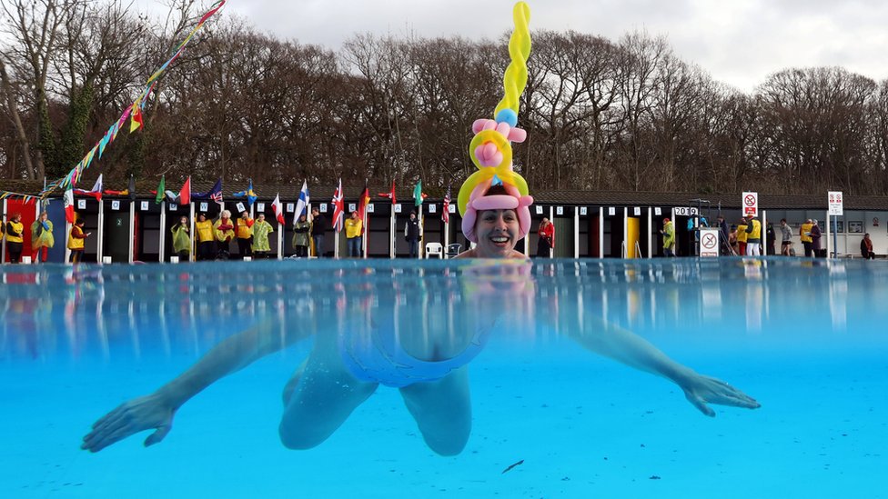 A woman participates in the Cold Water Swimming Championships at Tooting Bec Lido in south London