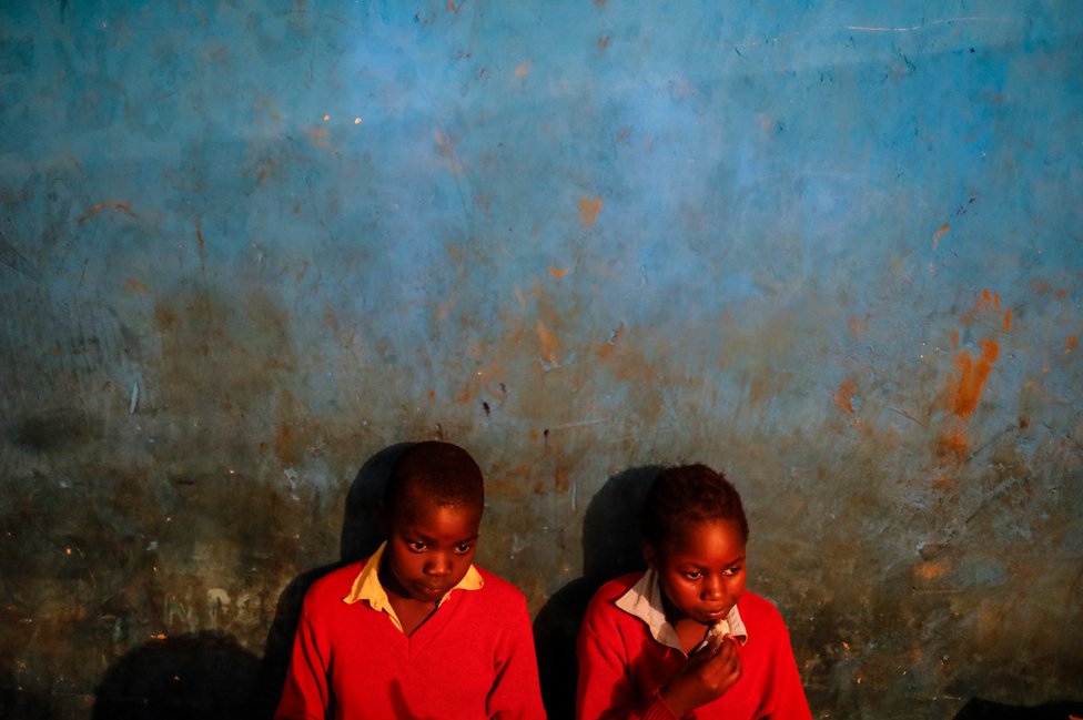 Children look on in a classroom during their lunch break at Fruitful Rescue Centre