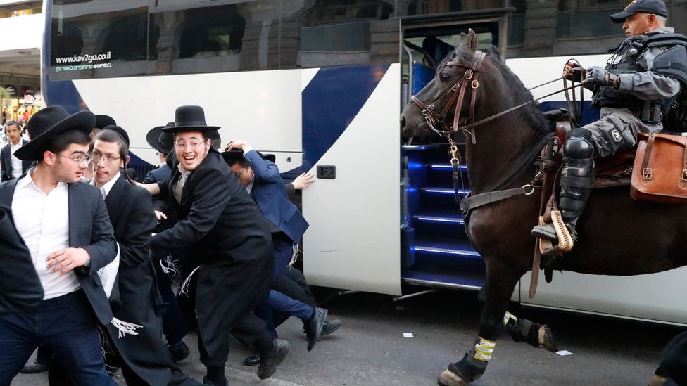 A mounted Israeli policeman disperses a group of Ultra-Orthodox Jews during a demonstration against Israeli army conscription in the Israeli city of Bnei Brak near Tel Aviv on 1 November 2019