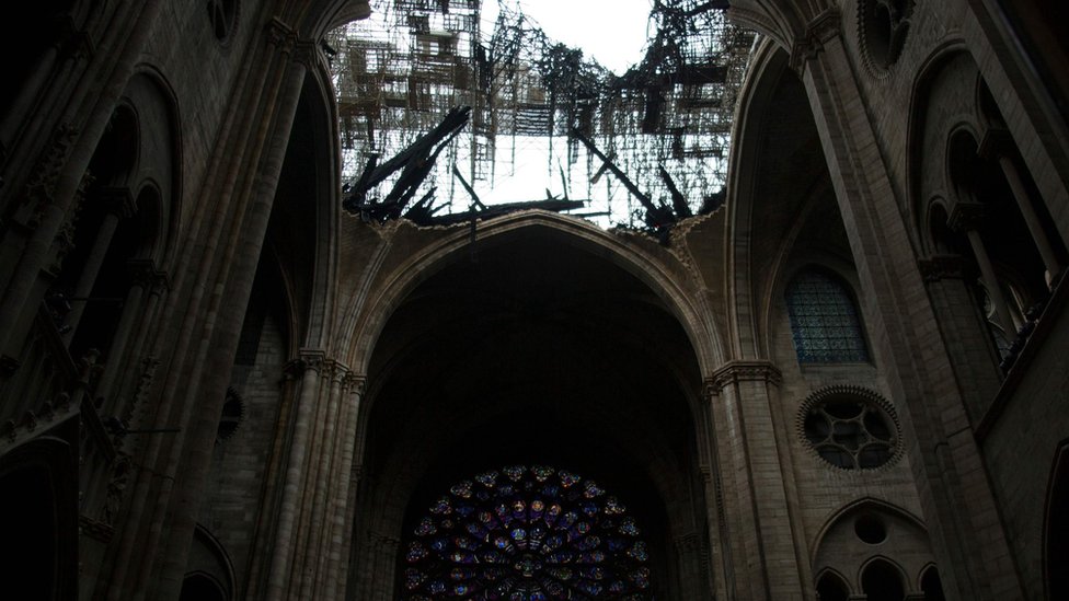 The rose windows below the damaged roof of Notre-Dame-de Paris Cathedral in Paris