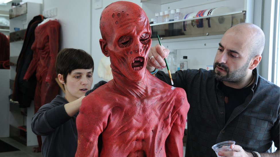 David Marti and another artist applying Javier's costume