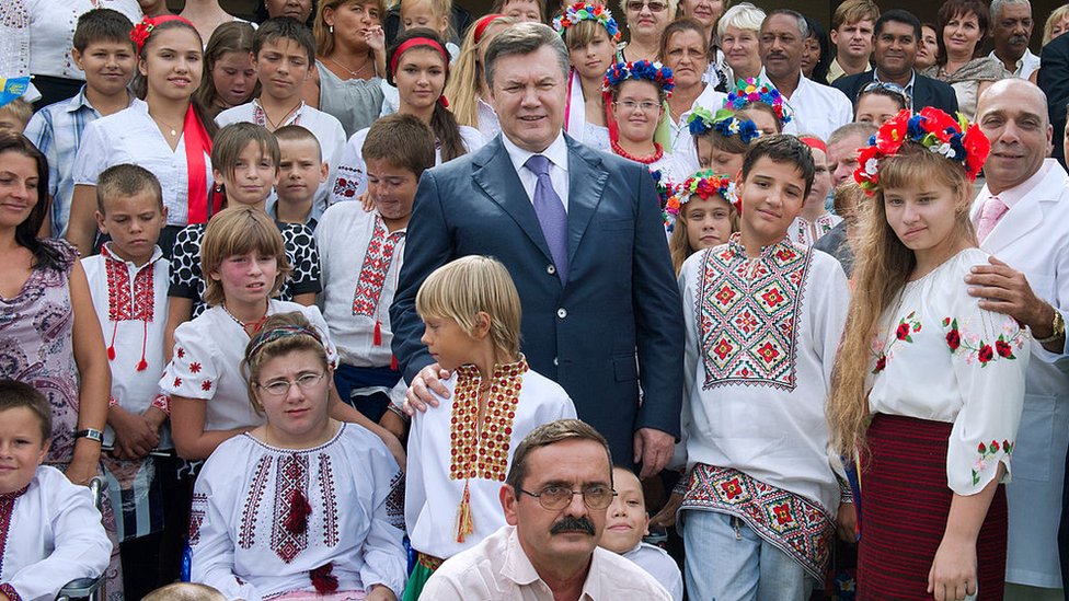 Ukraine's former president Victor Yanukovich poses with former patients of the Kids from Chernobyl programme