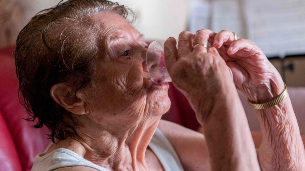 Šta se dešava u našim telima tokom ekstremnih vrućina 2 An elderly person drinks a glass of water to avoid heatstroke and dehydration in Clermont-Ferrand - central France