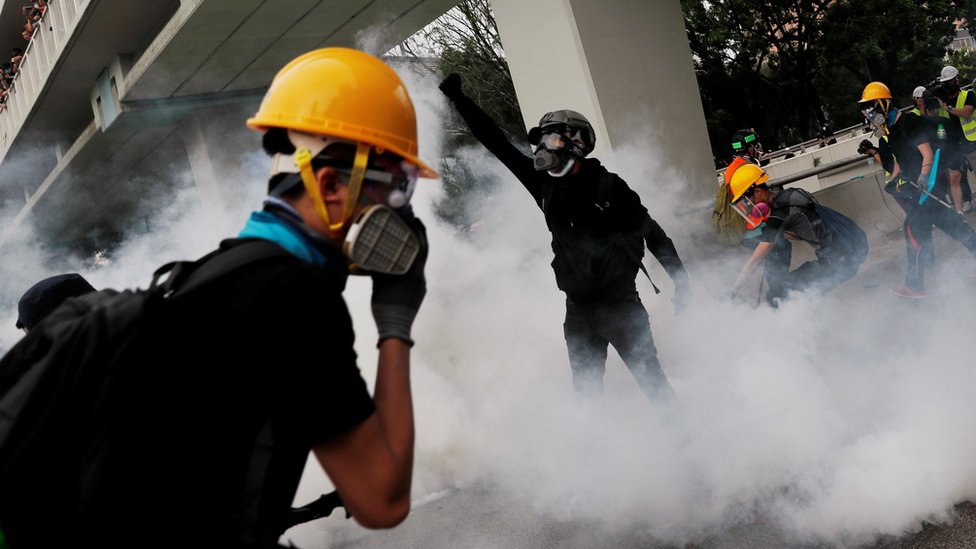 Demonstrators react to a tear gas during a protest against the Yuen Long attacks in Yuen Long, New Territories, Hong Kong, China July 27, 2019.