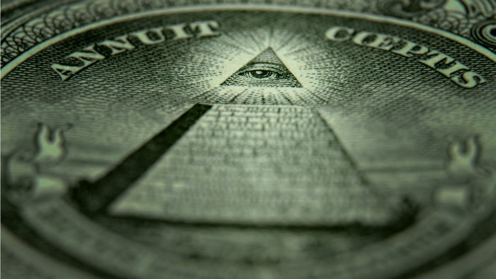 A close-up of the back of a one dollar bill with a symbol associated with secret societies.