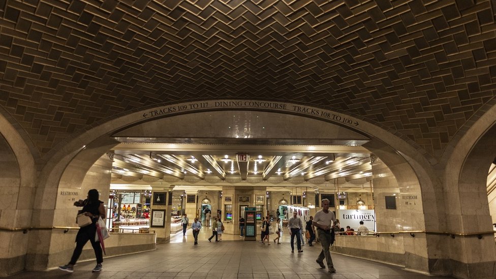 View of the tiled vault in the interior of the Grand Central Terminal in New York USA - with people walking by.