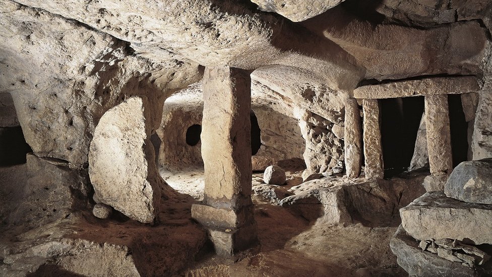 A view of the Hal Saflieni Hypogeum in Malta. Rock vaults underpinned in places by stone pillars.