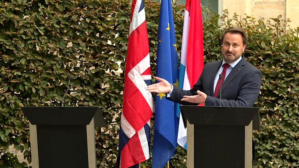 Luxembourg's Prime Minister Xavier Bettel gestures to an empty podium as he speaks to the press after meeting the UK Prime Minister in Luxembourg. 16 September 2019