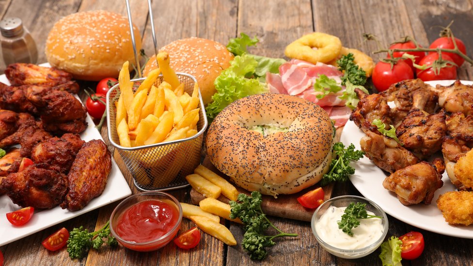 A variety of fast foods including burgers, chicken wings, chips etc.