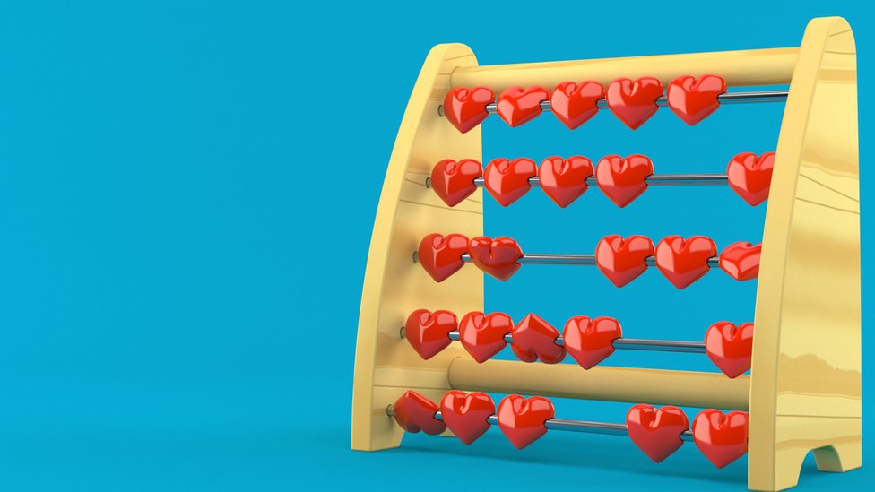 An abacus with red heart-shaped beads, over a bright blue background