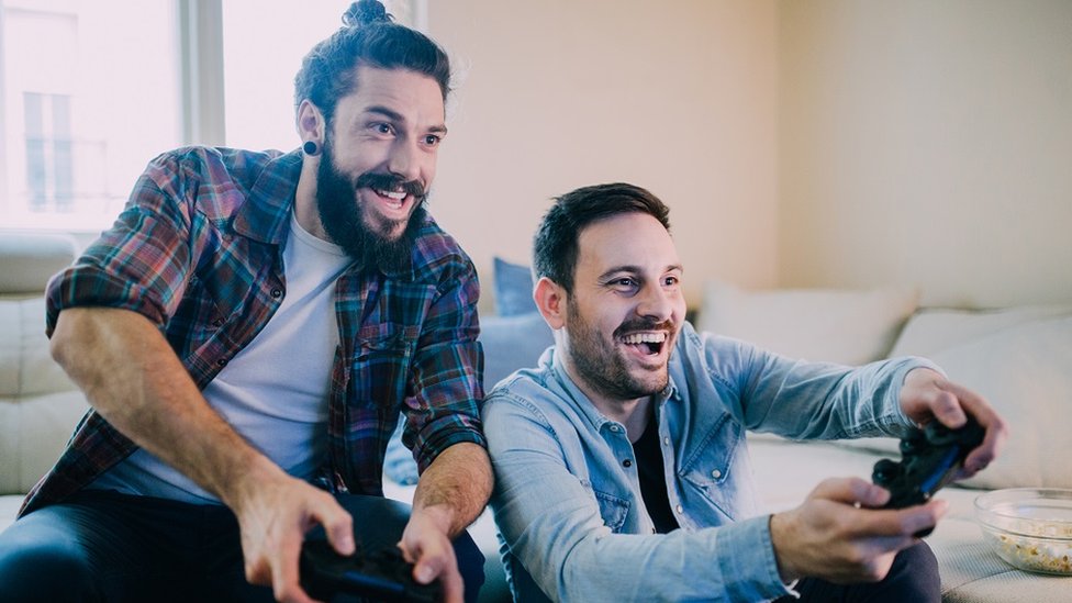 Two young men playing videogames