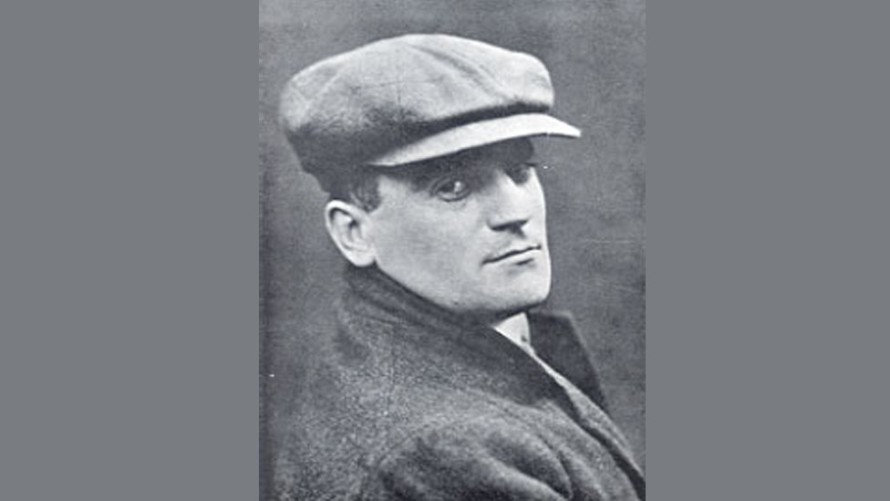 A portrait picture of Hugh Blaker wearing a hat