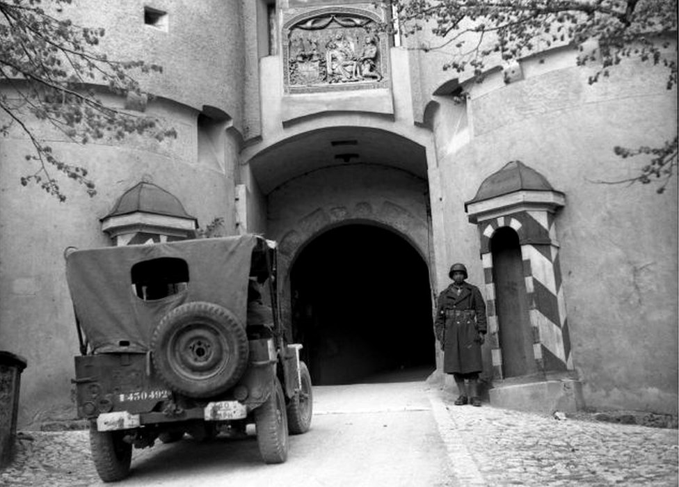 A French soldier guards the entrance to the castle in Sigmaringen, 23 April 1945