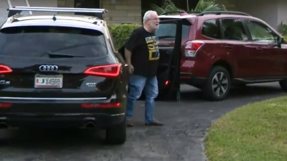 Professor Bruce Bagley gets out of a car outside his house