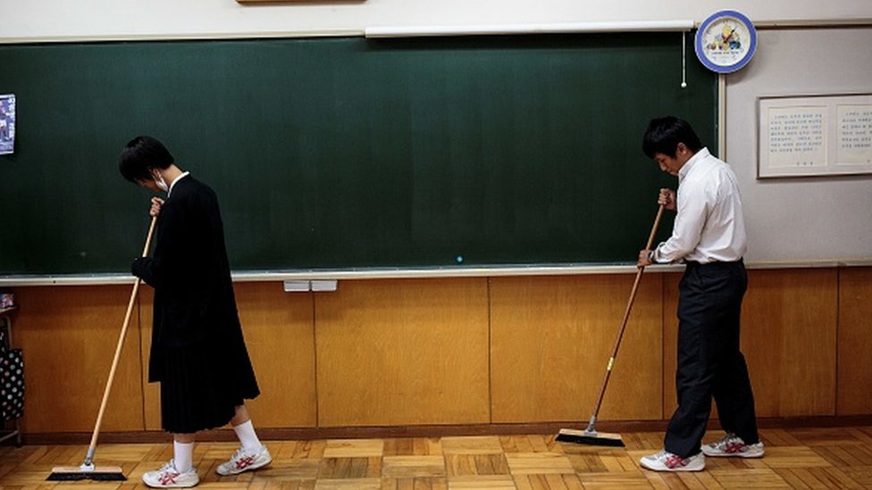 Students sweep their classroom at a Japanese school