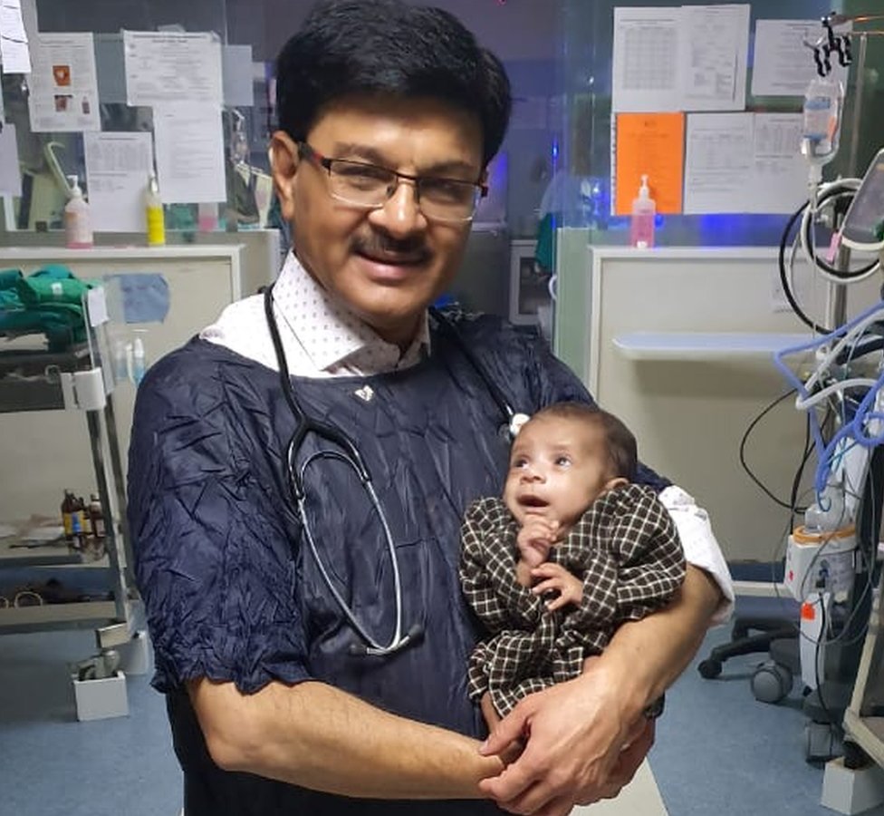 Dr Ravi Khanna with the baby in his hospital