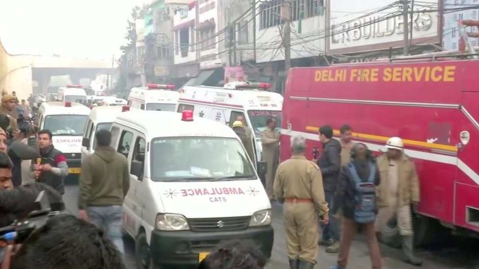 Ambulances and firefighters at the scene of the fire in Delhi