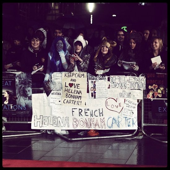 Helena Bonham Carter fans at a premiere, holding posters and autograph books
