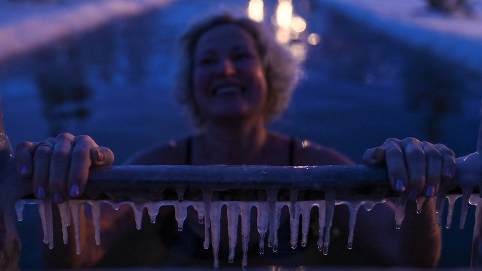 A woman takes a dip during celebrations of Orthodox Epiphany in Omsk