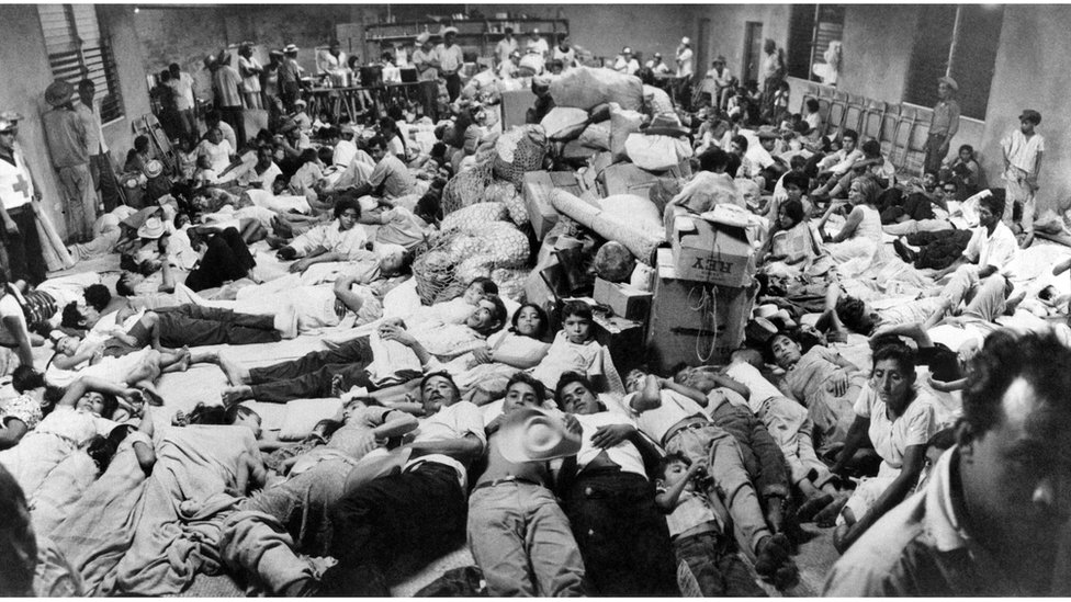 Salvadoran migrants at a Red Cross post