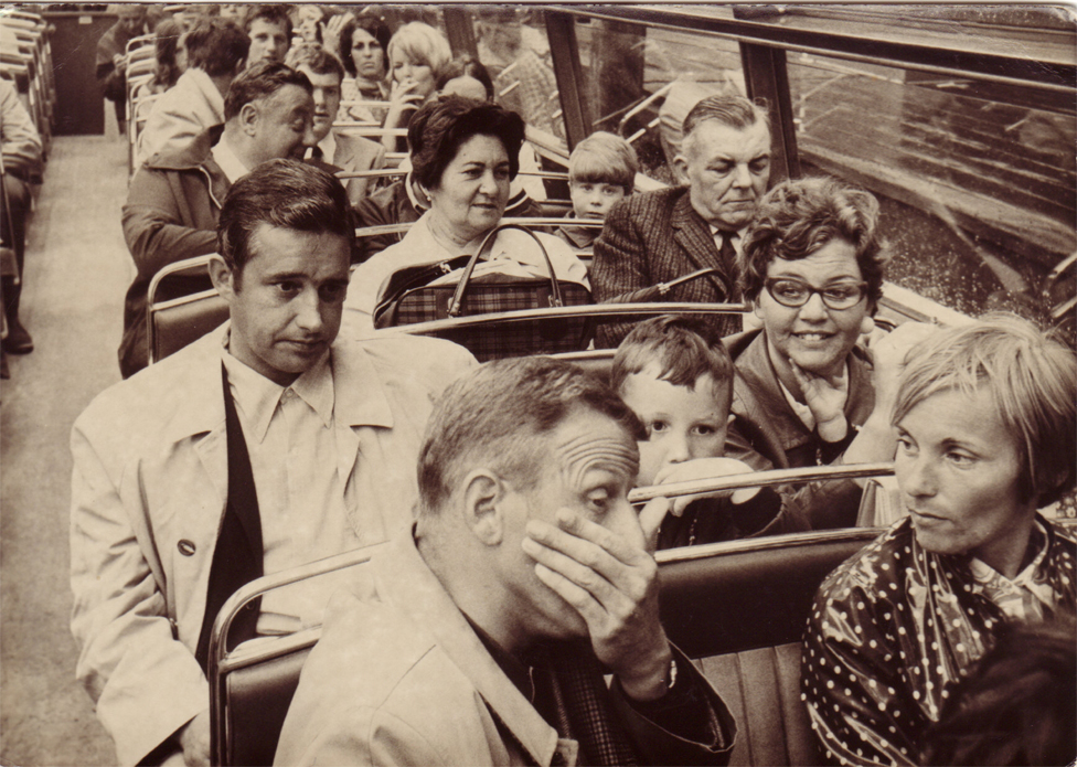 Mary and her husband on a London bus (third row back)