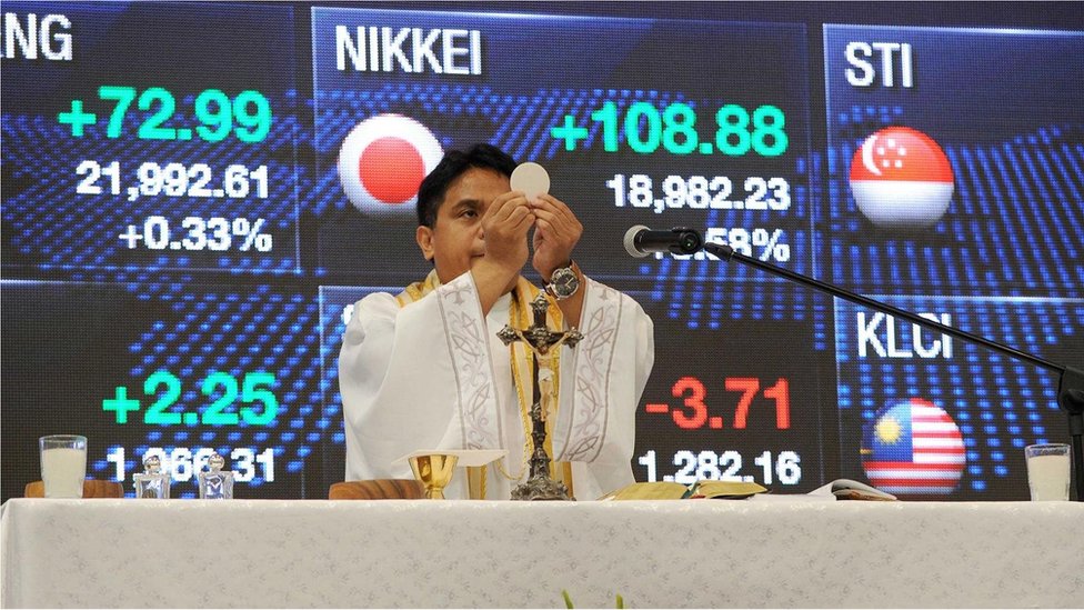 Bogovi sutrašnjice: Kako izgleda budućnost religije 6 Rimokatolički sveštenik drži misu prvog dana rada Filipinske berze u Manili