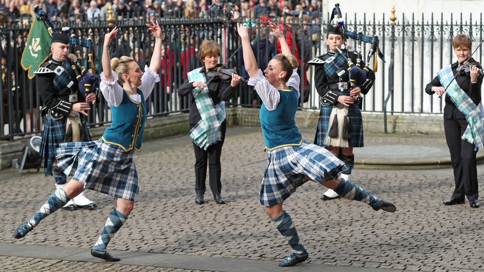 Highland dancers and musicians performing outside Westminster Abbey ahead of the service
