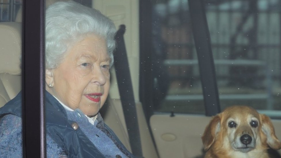 The Queen with one of her corgis, leaving Buckingham Palace