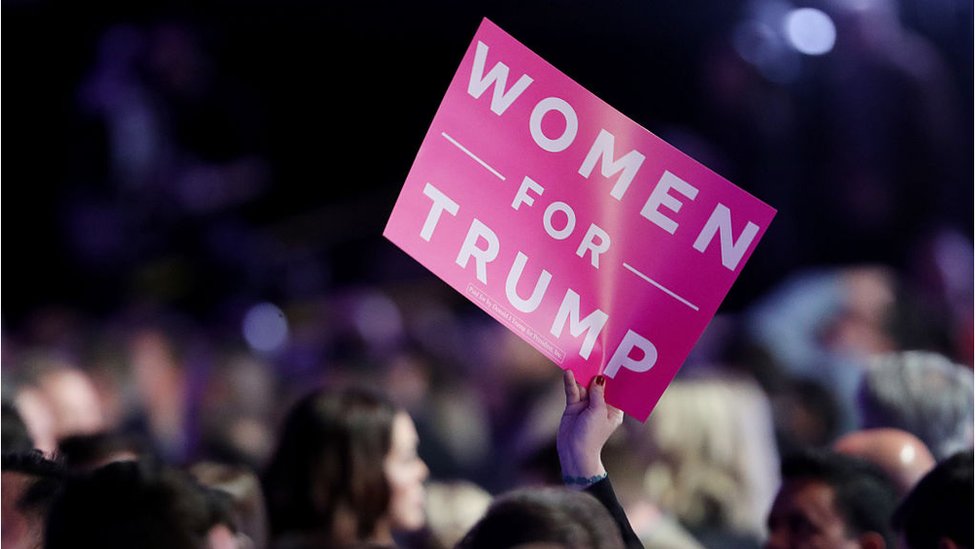 An attendee holds up a sign in support of Republican presidential nominee Donald Trump that reads "Women For Trump" during the election night event in 2016