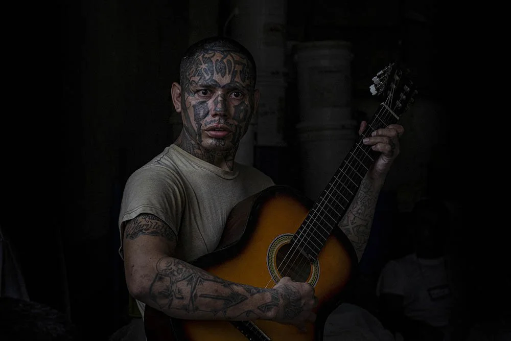 An inmate and former La 18 gang member plays the guitar at the Penal San Francisco G&oacute;tera, El Salvador. November 8, 2018.