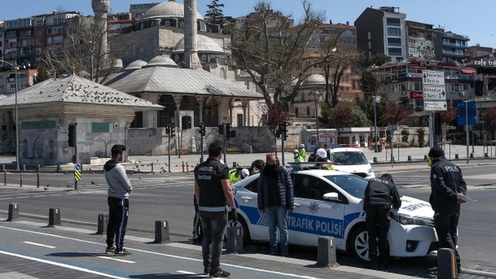 Turkish police fine some people who violate the two-day curfew during lockdown in Istanbul, Turkey, 12 April 2020