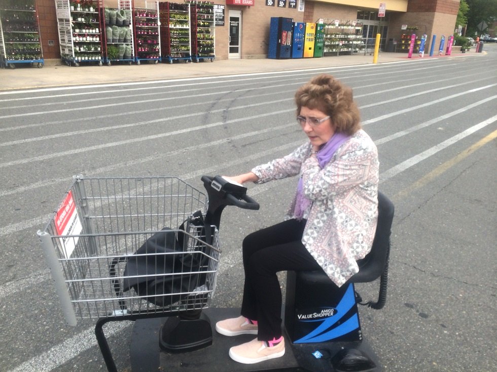 Kathleen riding a motorised shopping cart at US store Walmart