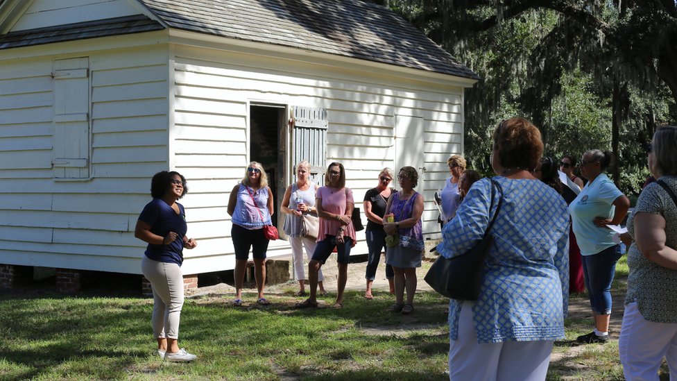 Olivia leading a tour in front of what used to be the kitchens where enslaved women worked
