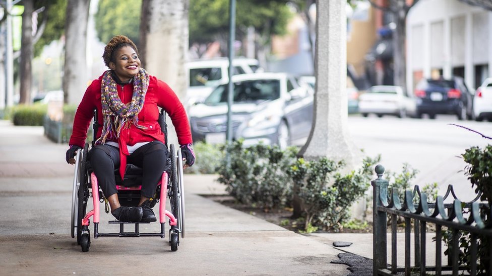 Young woman on a wheelchair out and bout