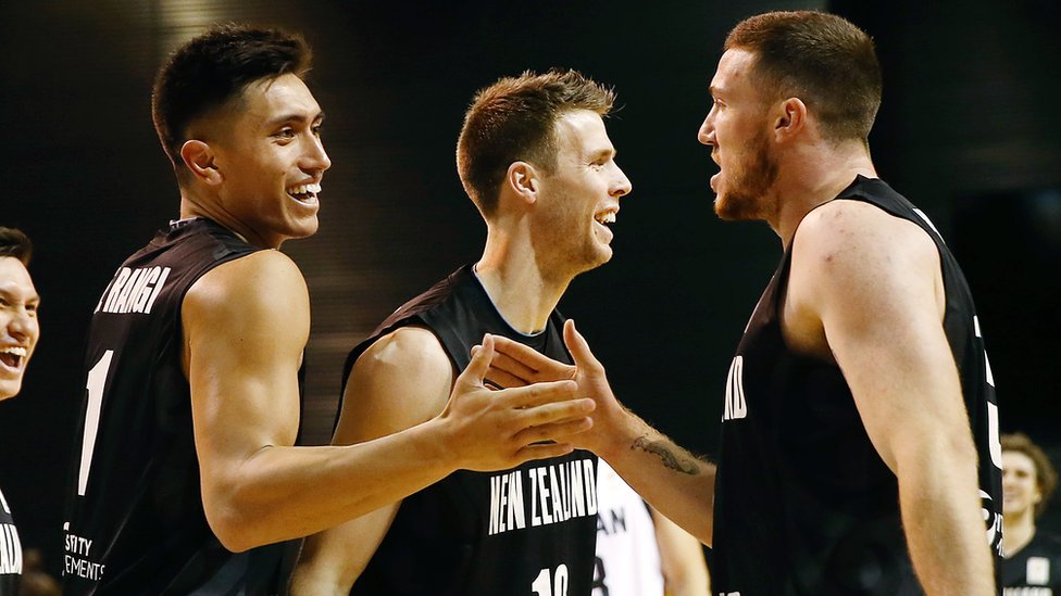 New Zealand basketball players celebrate during a match against Jordan