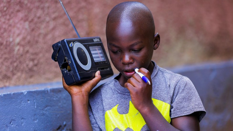 Dečak u Ruandi sluša nastavu preko radija