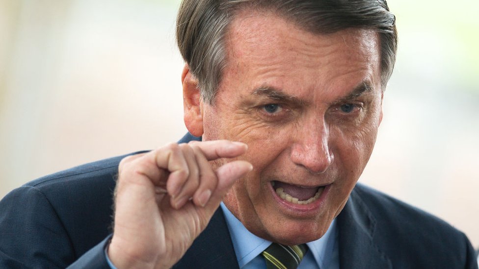Brazilian President Jair Bolsonaro gestures during a press conference amidst the coronavirus pandemic on March, 25, 2020 in Brasilia, Brazil. Bolsonaro recently defended the nation's return to normality and the end of social distancing and quarantine.