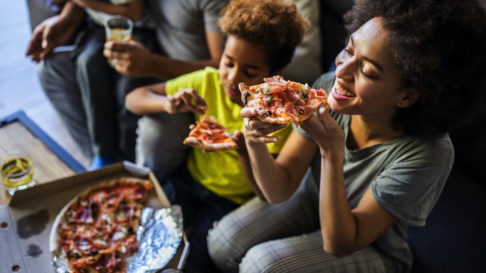 Letovanje kod kuće tokom pandemije: Kako uživati u odmoru bez putovanja 2 Porodica jede picu