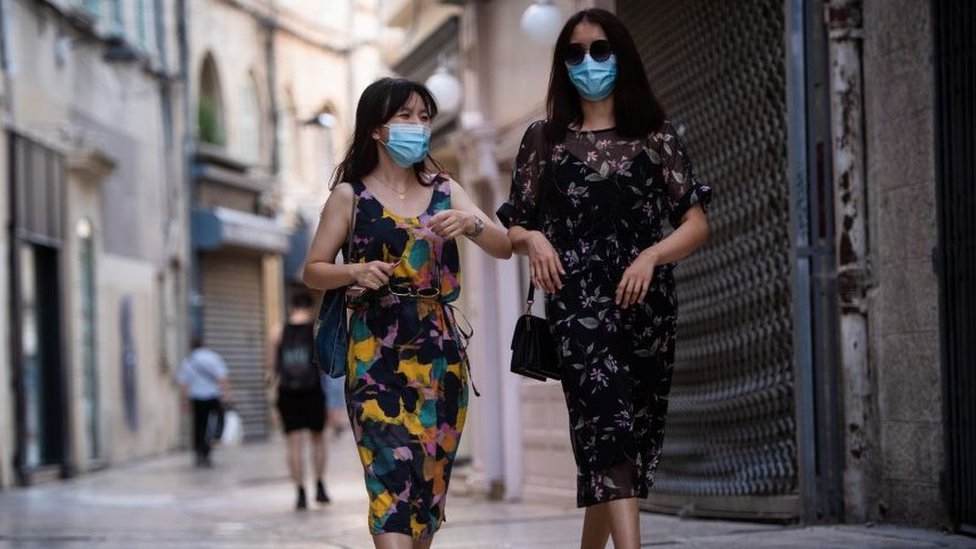 French women walking down the street wearing face masks in Avignon, July 2020