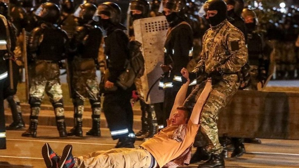 A police officer drags a man during clashes with opposition supporters in Minsk, Belarus. Photo: 9 August 2020