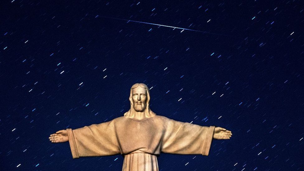 A Perseid meteor crosses the night sky over a statue of Jesus Christ in the village of Ivye some 125 km west of Minsk, on 13 August 2016.