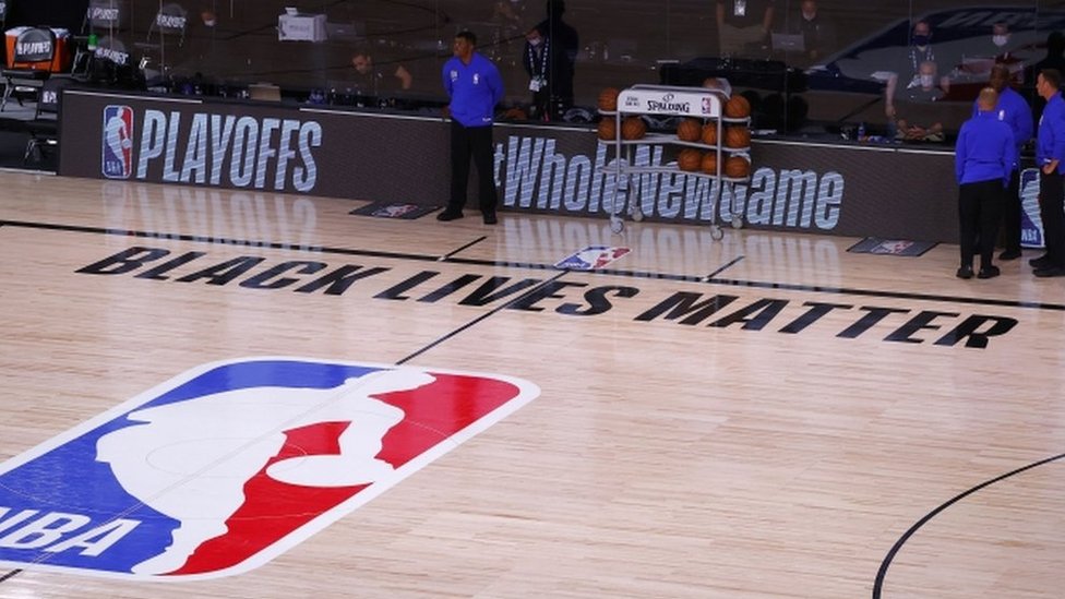 Referees on an empty court after the Milwaukee Bucks boycott an NBA play-off game