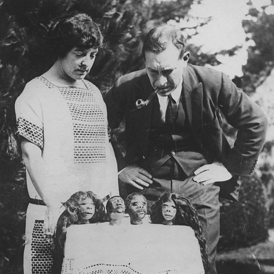 British explorer Lady Richmond Brown reviews her collection of shrunken heads, obtained from the Tibolo and Jivaro tribes of South America, circa 1925.