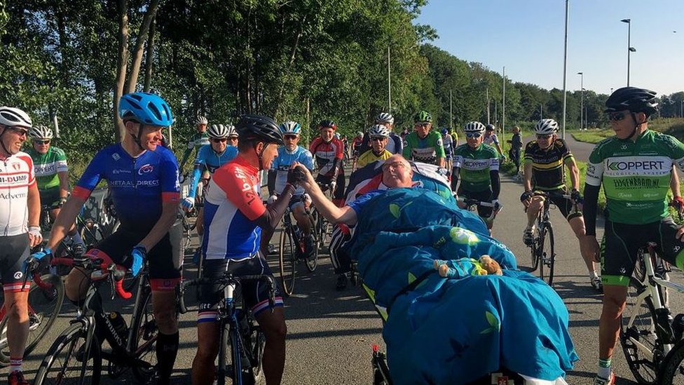 A terminally ill man is greeted by cyclists