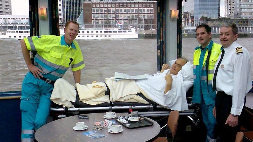 A patient on a stretcher on a tug boat