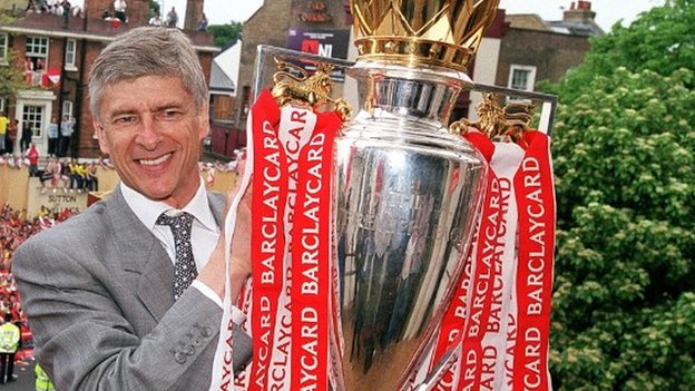 Arsene Wenger holds Premier League trophy